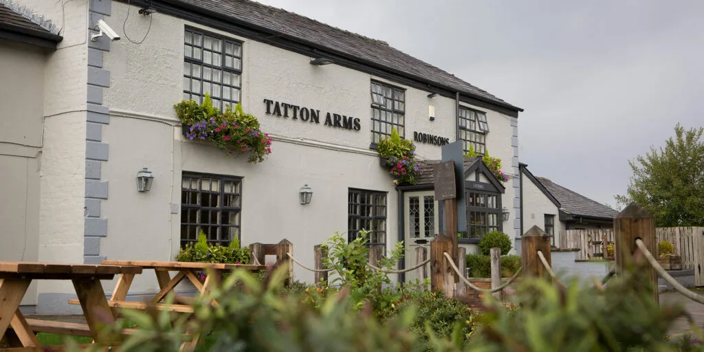 External picture of the Tatton Arms pub and restaurant with beer garden near Manchester Airport and Wythenshawe.
